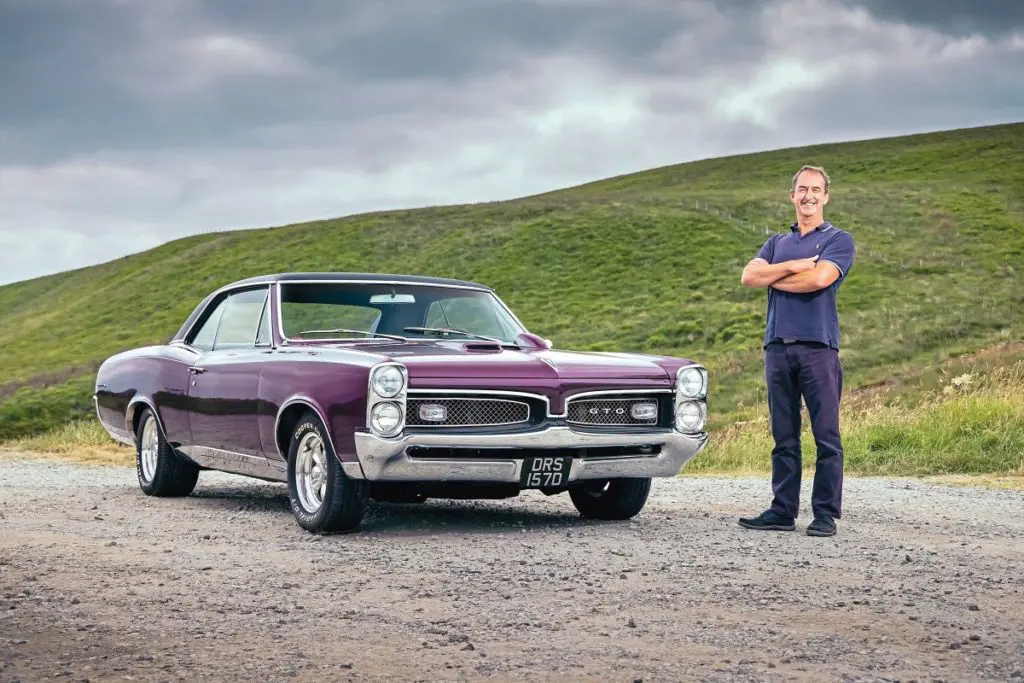 Ian with his purple 1967 Pontiac GTO.