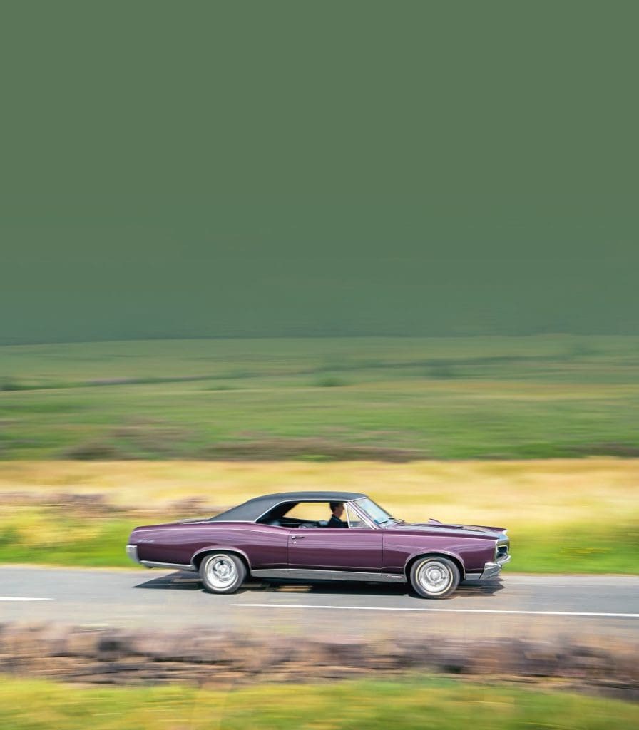 Ian driving the 1967 Pontiac along a countryside road