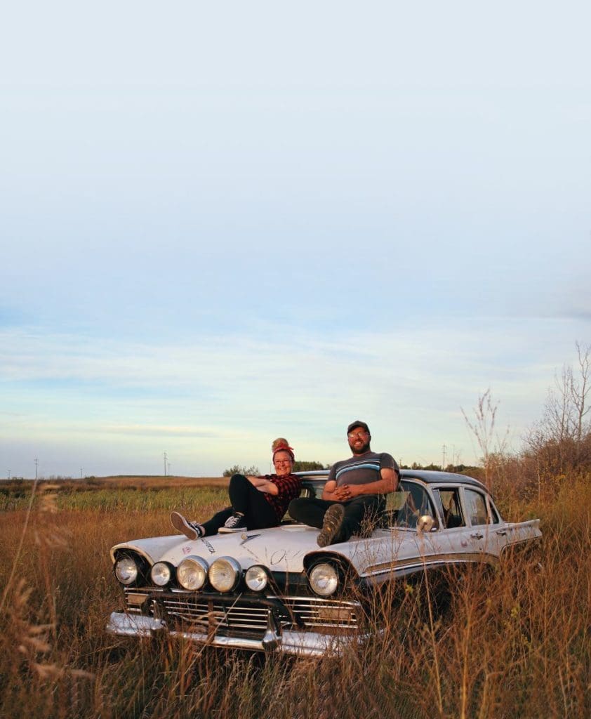 Andrew Scott with partner Jen sitting on the hood of the 1957 Ford Custom