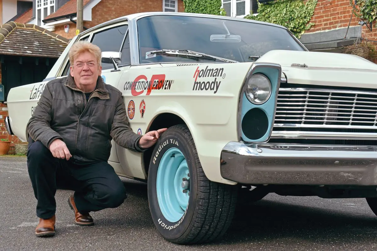 Dave crouching beside his Ford Custom