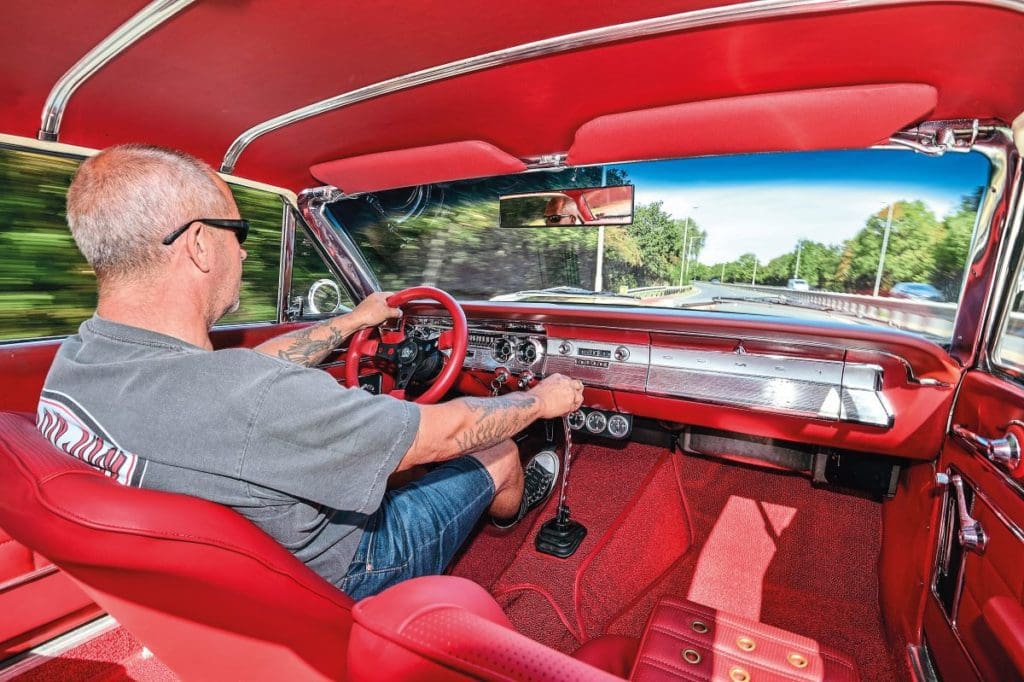 Marc behind the wheel in the red interior of the 1964 Mercury Comet