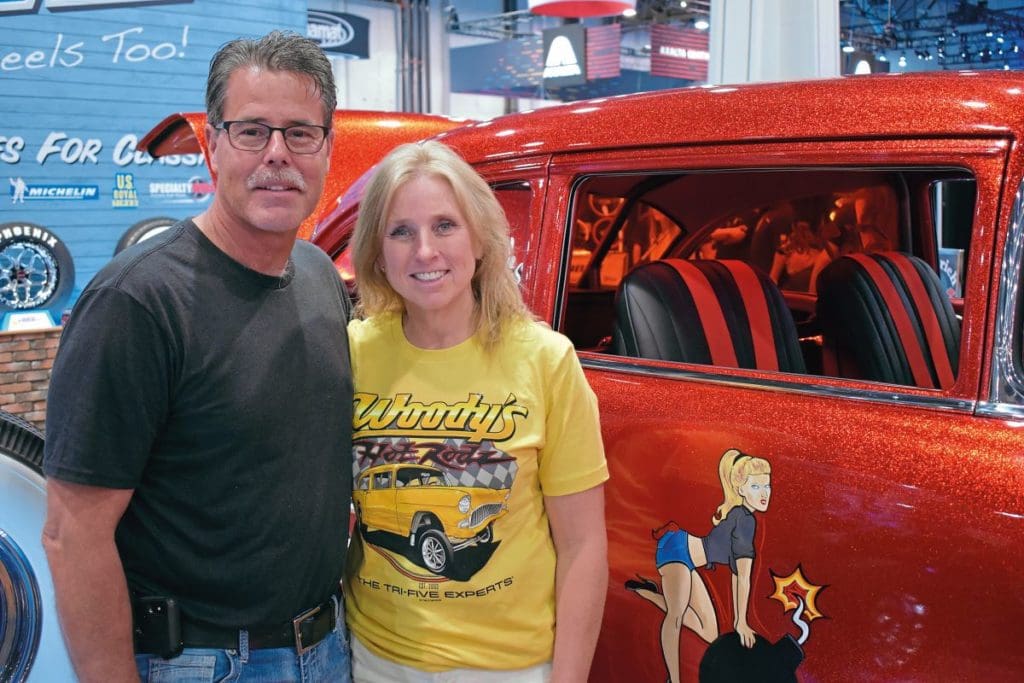 Owners Jeff and Tracy Spears stand in front of the red Chevy 210 Cherry Bomb