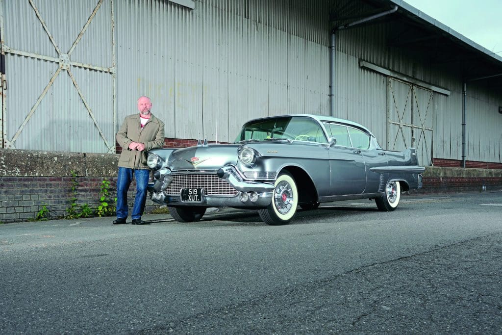 Simon next to his silver '57 Cadillac Sedan De Ville