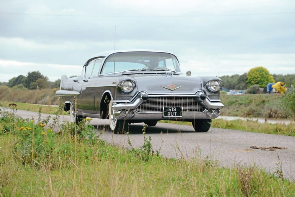 Cadillac Sedan De Ville driving along a road