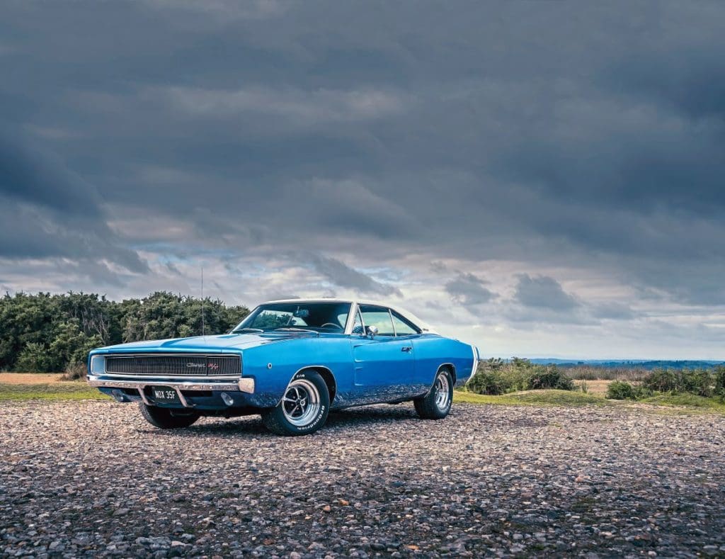 Blue 1968 Dodge Charger against cloudy sky