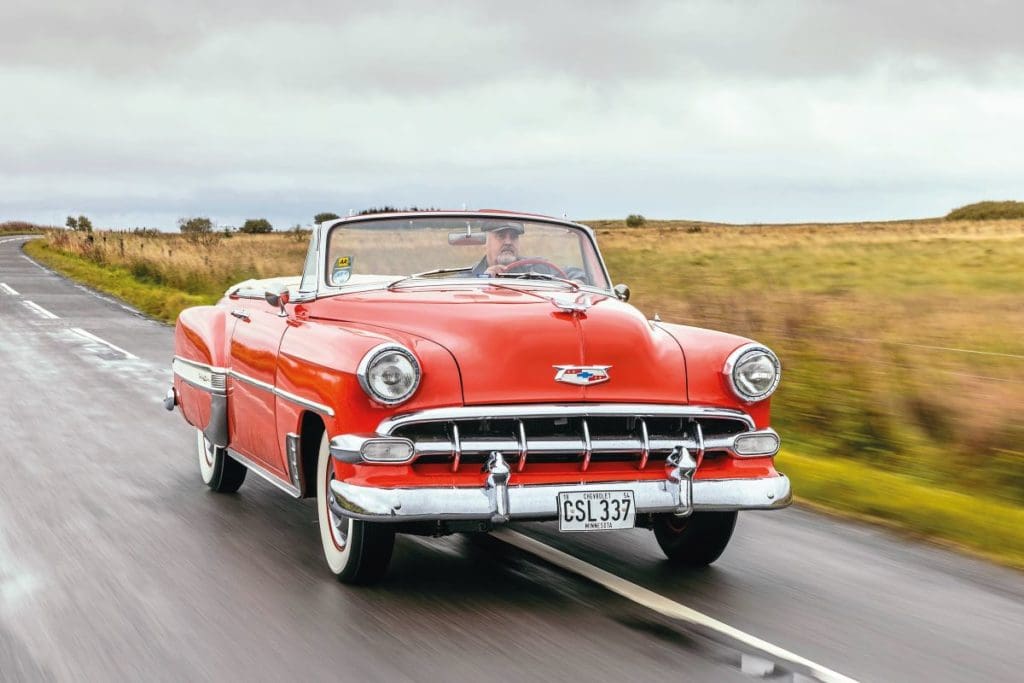 1954 Chevrolet Bel Air driving down a Glasgow road