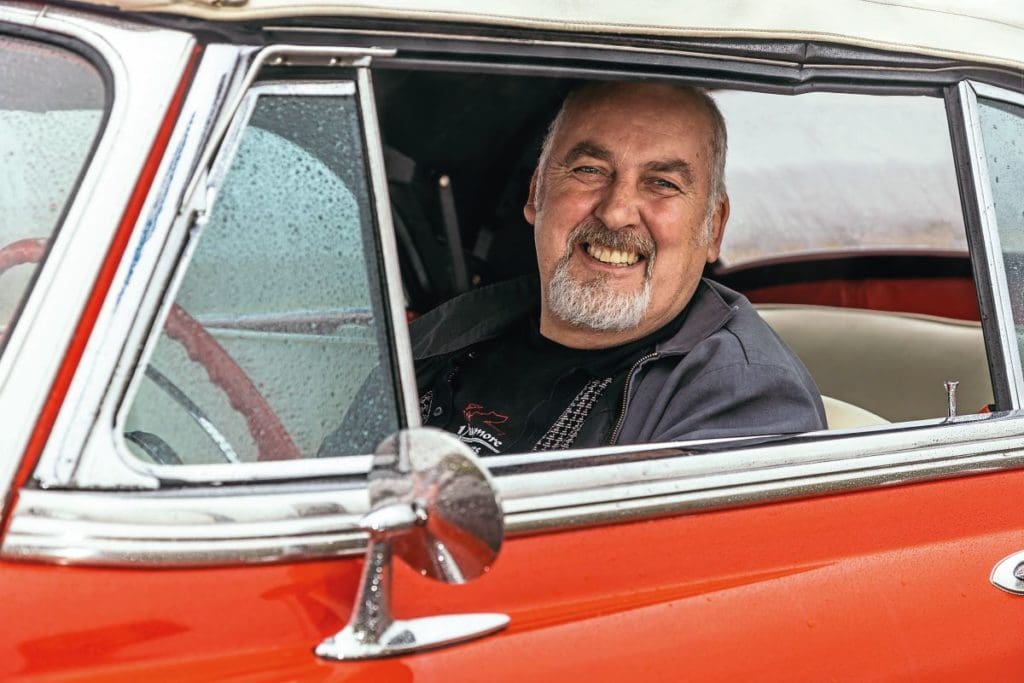 Owner Bruce smiles from the driver's seat of the Bel Air