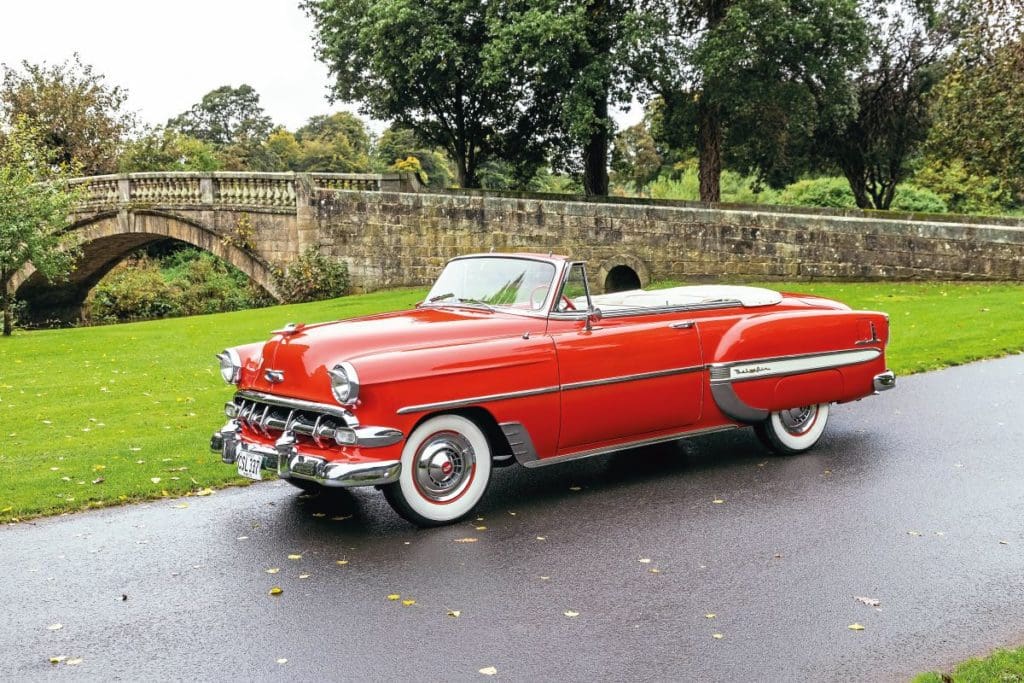 1954 Chevrolet Bel Air parked with a bridge in the background