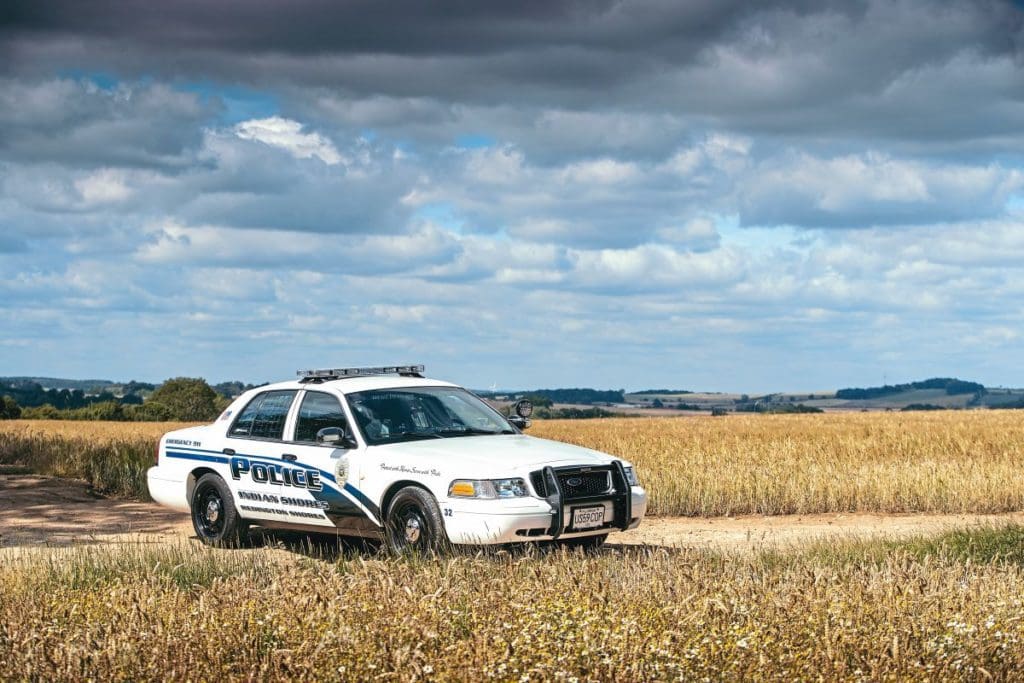 2011 Ford Crown Victoria P7B Interceptor American police car in a field.