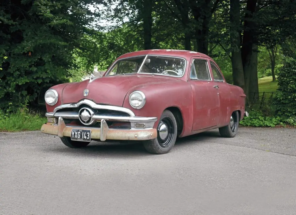 1950 Ford Custom Club Coupe parked in front of trees