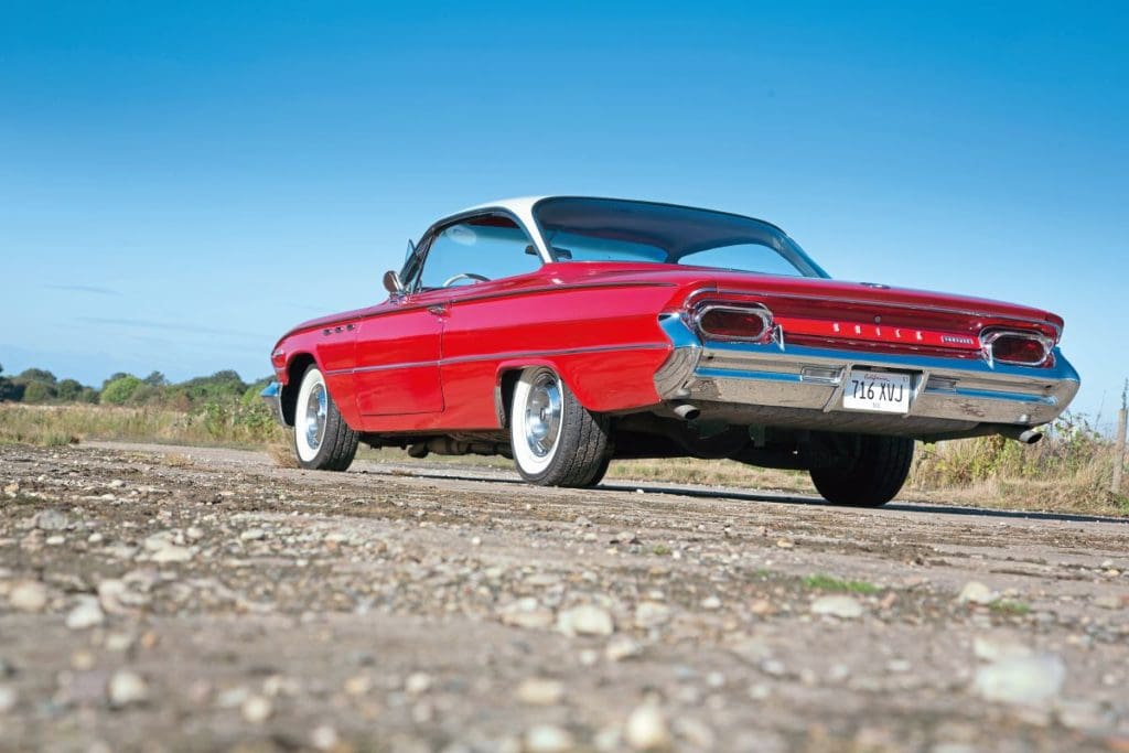 1961 Buick Invicta on the road from the back, showing off whitewalls