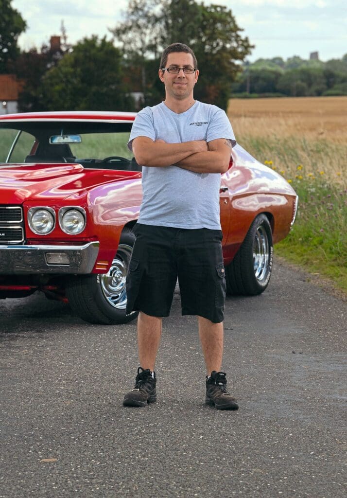 Chris standing in front of his car